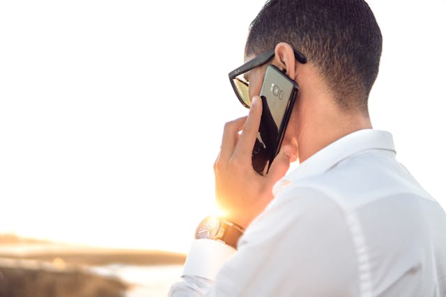 Person holding a cell phone to their ear